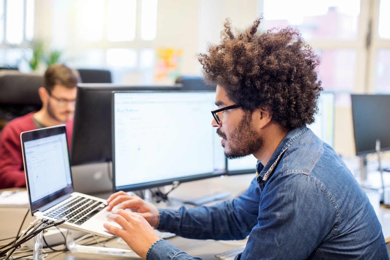 Man with afro hairstyle working at his desk
